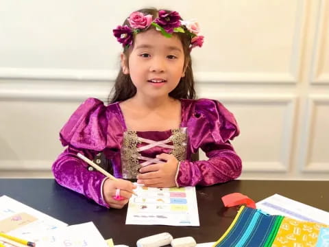 a girl sitting at a table