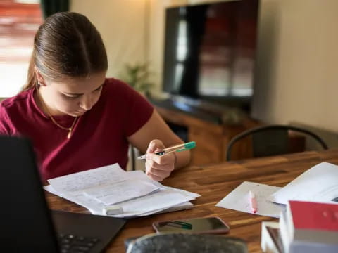 a person writing on a piece of paper