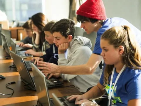 a group of people working on computers