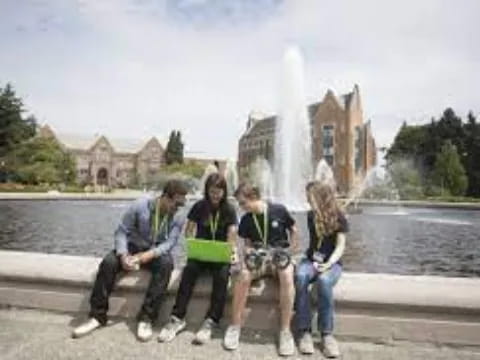 a group of people posing for a photo in front of a fountain