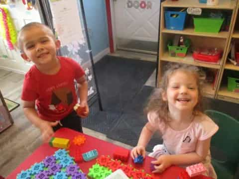 a boy and girl playing with toys