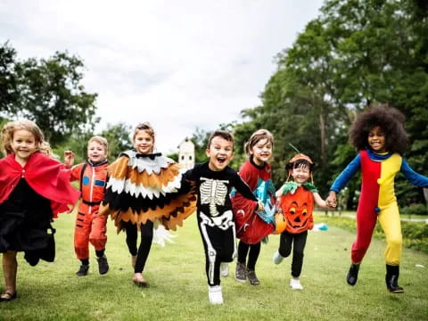 a group of children running in a field