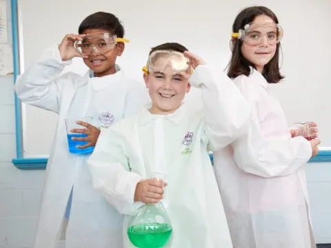 a group of people wearing lab coats and holding beakers