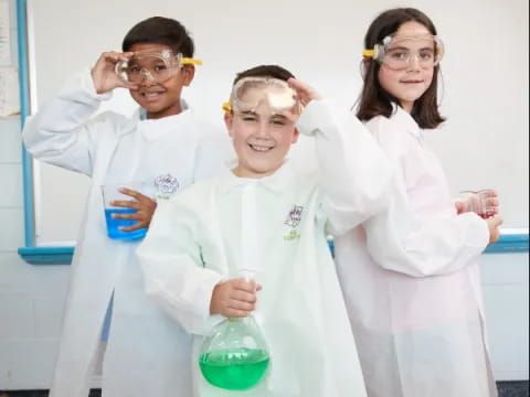 a group of people wearing lab coats and holding beakers