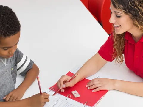 a man and a boy looking at a paper