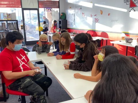 a group of children sitting at desks in a classroom