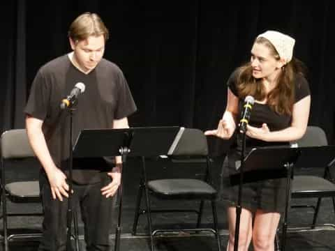 a man and a woman singing on stage