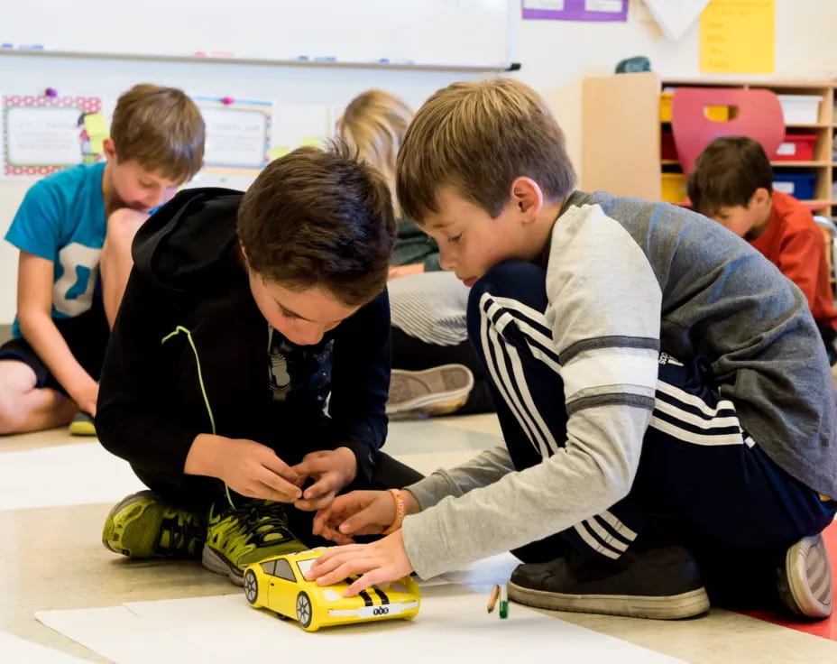 a group of children playing with a toy