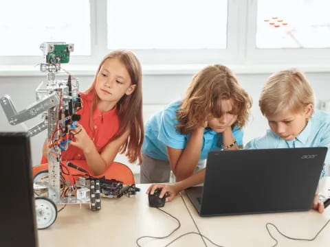 a group of kids working on a computer