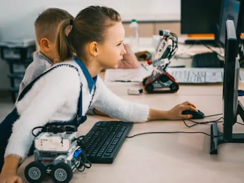 a young girl and a young boy playing with a toy car