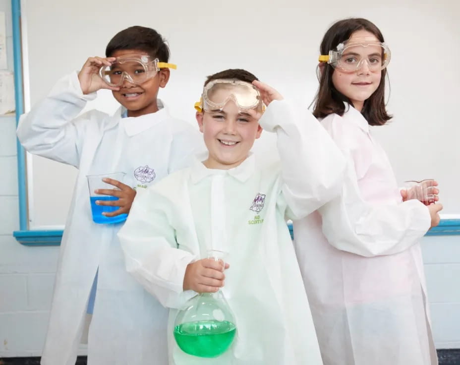 a group of people wearing lab coats and holding beakers