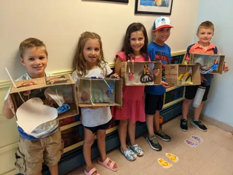 a group of children holding boxes