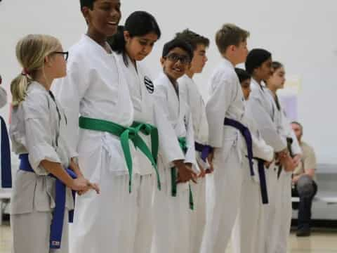 a group of people wearing white karate uniforms