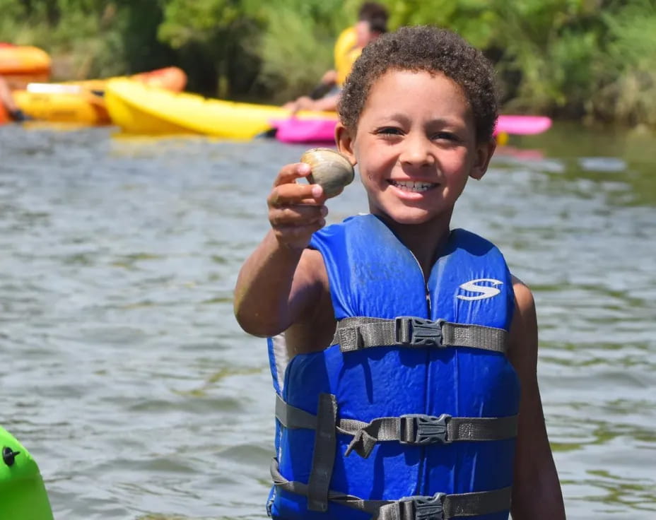 a boy holding a fish