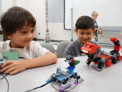 a couple of boys playing with toy trains