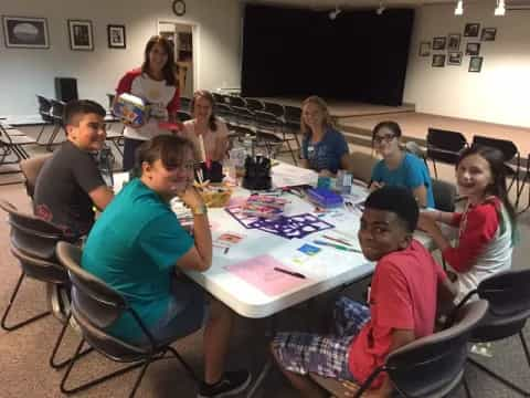 a group of people sitting around a table