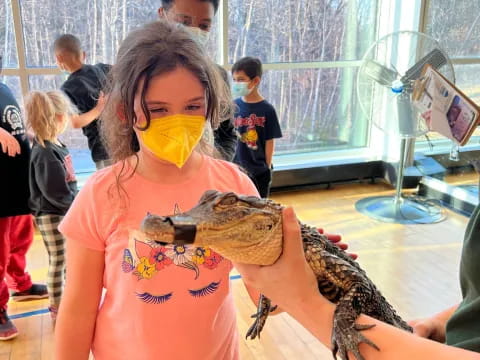 a child holding a lizard