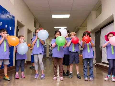 a group of children holding balloons