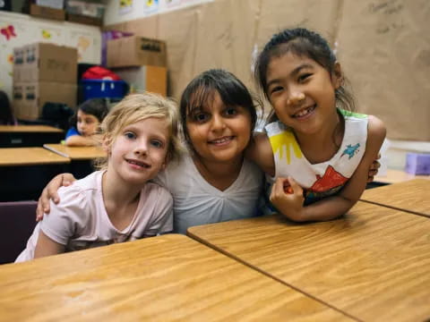 a group of children sitting at a table