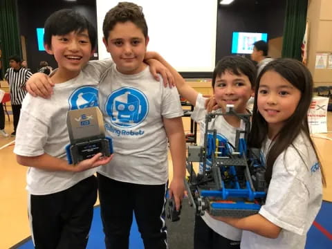 a group of kids holding up a trophy