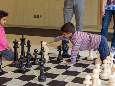 a boy and girl playing chess