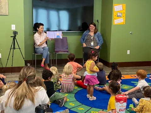 a group of people sitting on the floor in front of a person