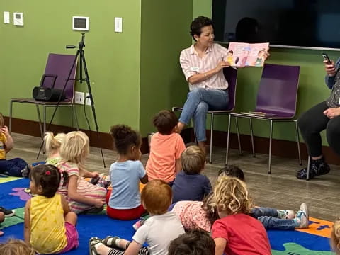 a person sitting in front of a group of children