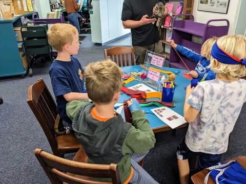 a group of children sitting at a table