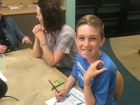 a boy sitting at a table