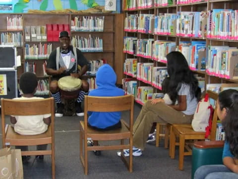 a group of people sitting in chairs in a library