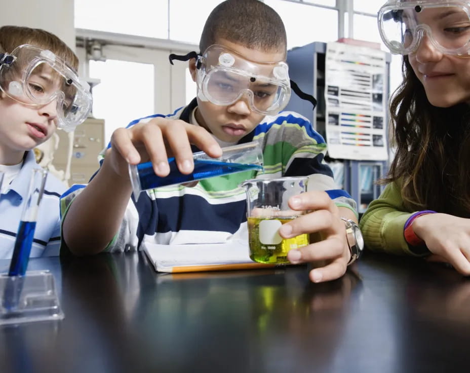 a group of people wearing safety goggles and holding cups