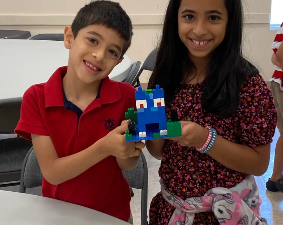 a boy and girl holding a box