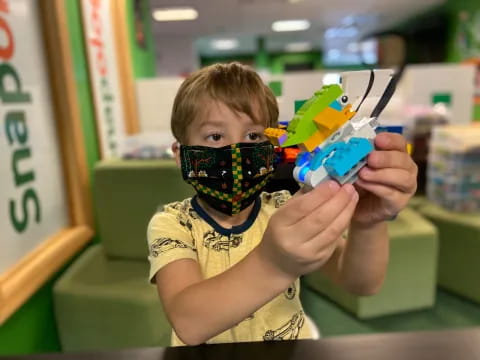 a boy holding a toy gun
