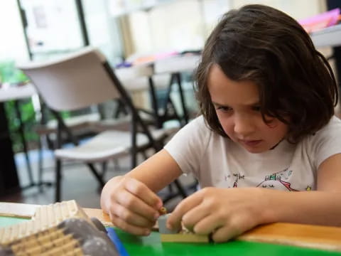 a young girl sitting at a desk