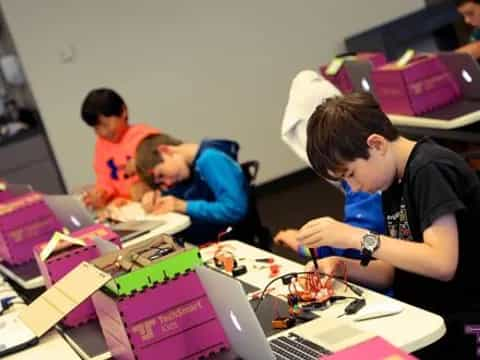 a group of people working on a laptop