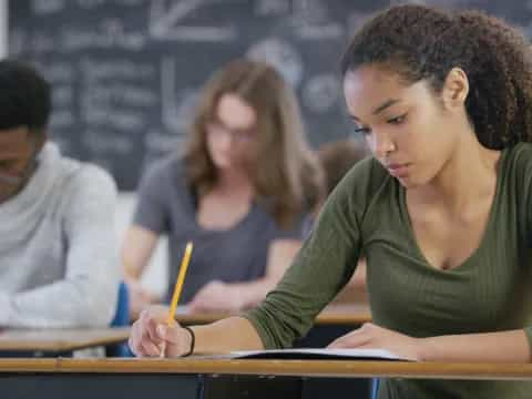 a person writing on a piece of paper