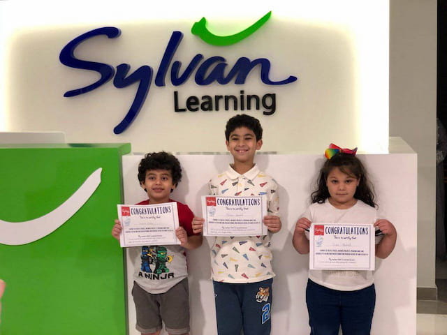 a group of children holding signs