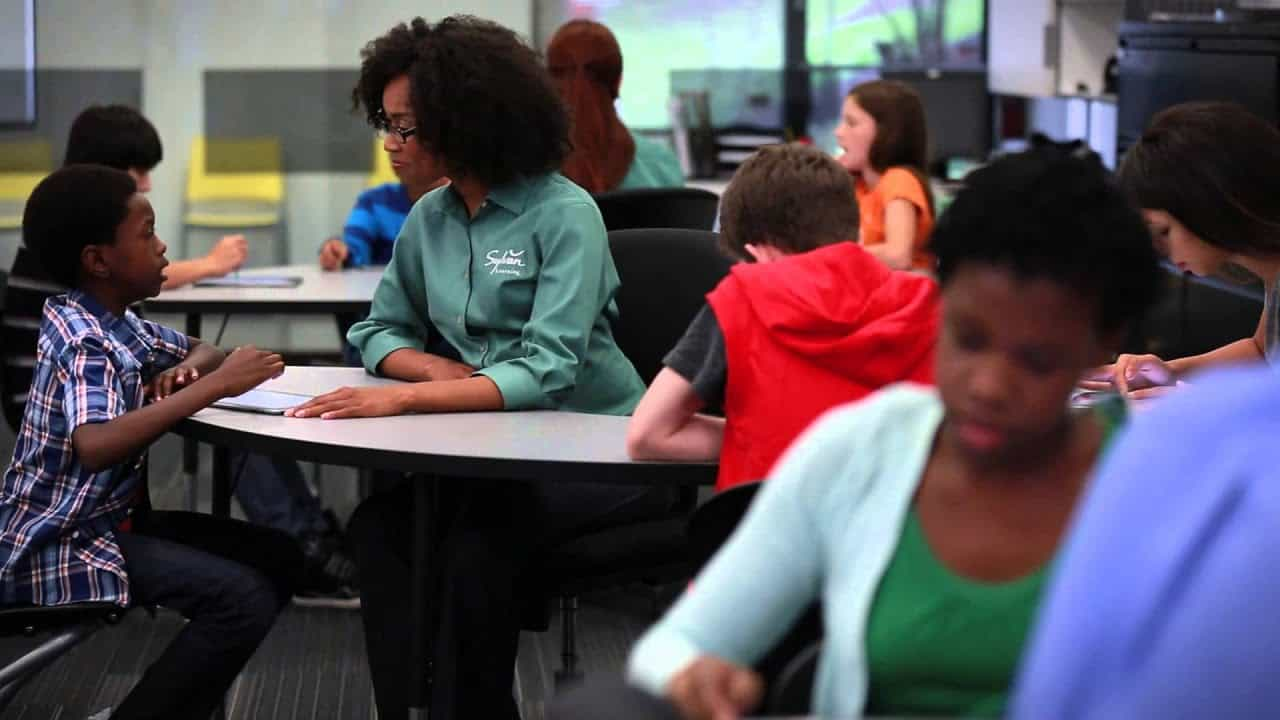 a group of people sitting at desks