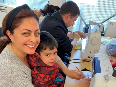 a man and a child looking at a computer screen