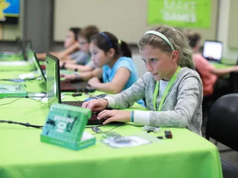 a group of people working on laptops