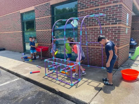 a group of people playing with a toy