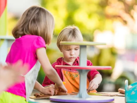 a couple of children playing with a toy