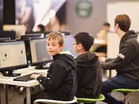 a group of people sitting at computers