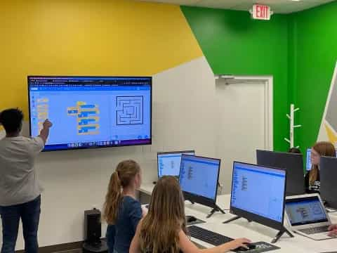 a group of people in a room with computers