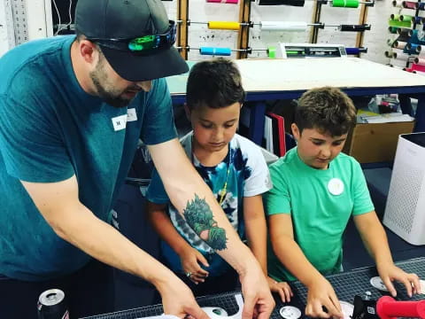 a man and two boys working on a project