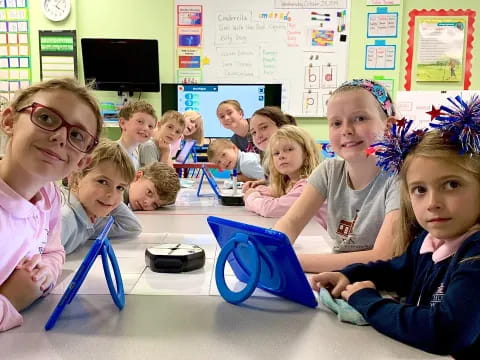 a group of children sitting at a table