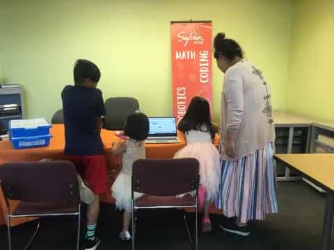 a person and several children in a classroom