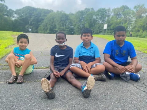 a group of boys sitting on the ground