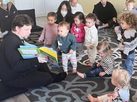 a group of children sitting on the floor reading books