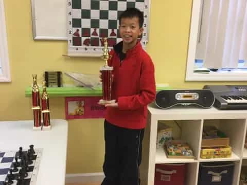 a boy holding a trophy